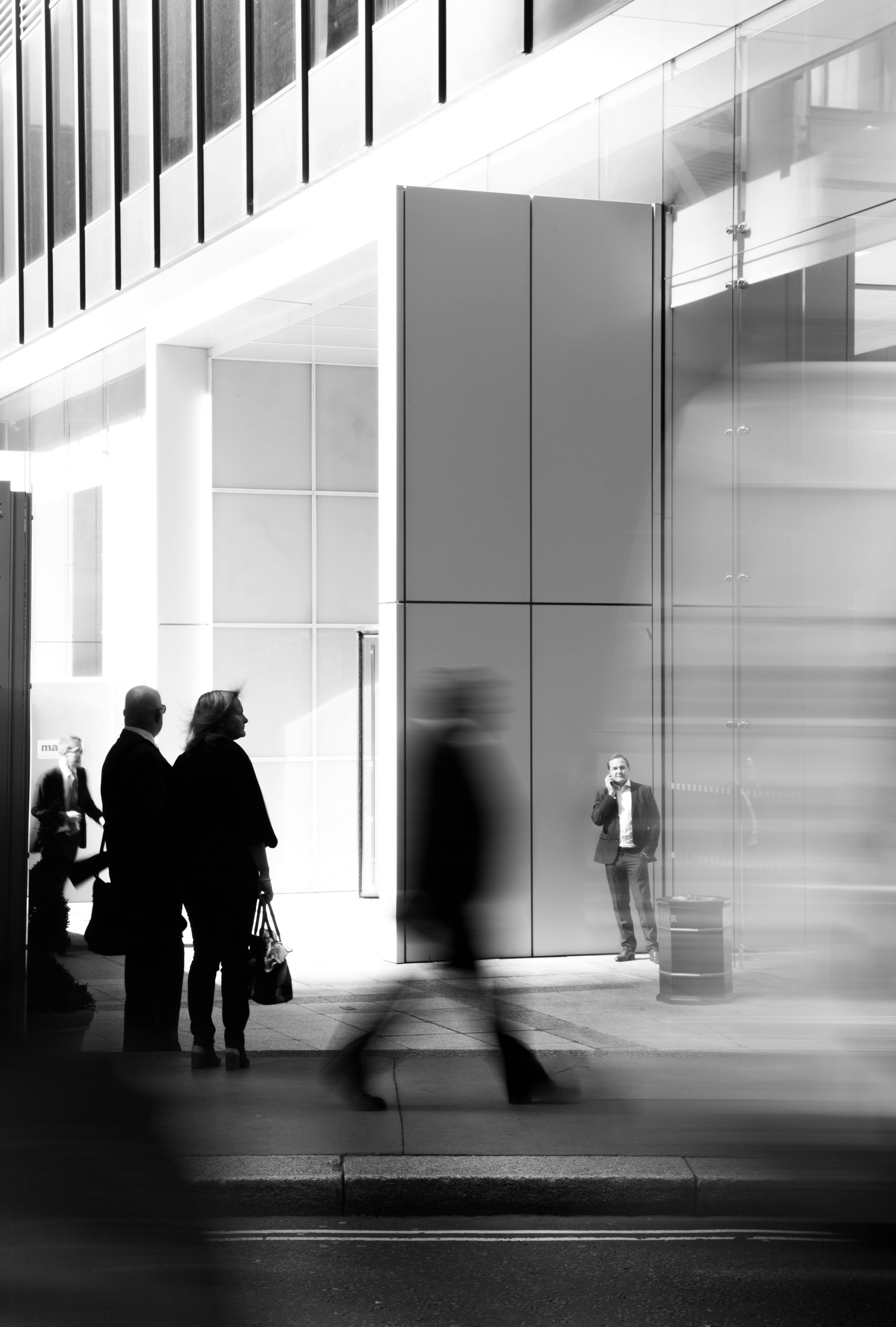Professionals moving through a modern glass office building