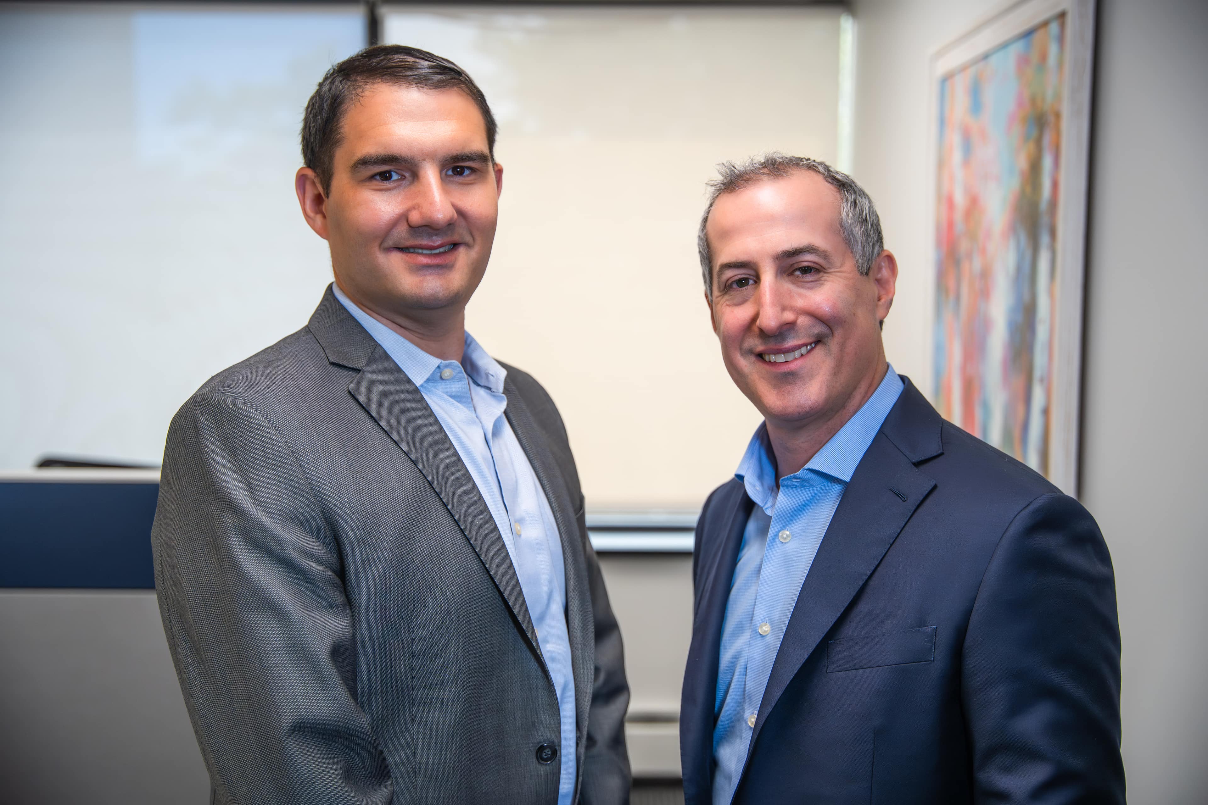 Two colleagues standing together in the Lilling office